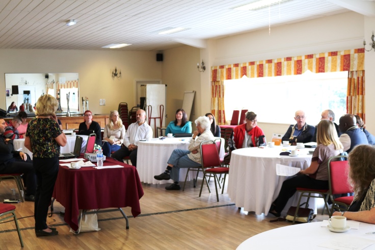 Two groups of people listening to a presentation.